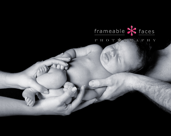 Newborn Photo in parents hands, Frameable Faces Photography
